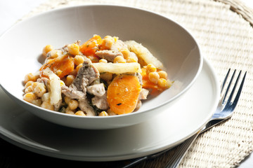 pork meat on celery with carrot and chick peas