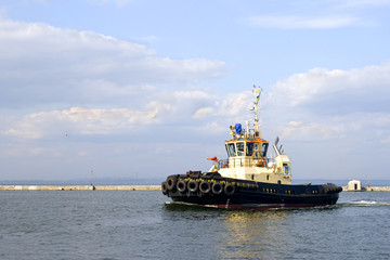 Tug boat is moving in the port