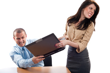 Business colleagues fighting for a laptop