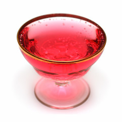 glass with red aerated water