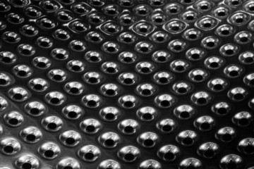 concave metal surface background with holes