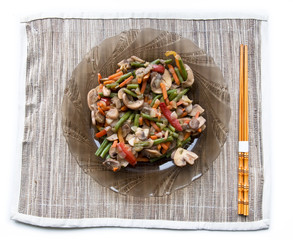 Plate with grilled vegetables and chopsticks.