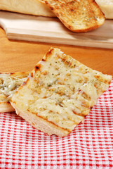 garlic bread on red white checkered napkin