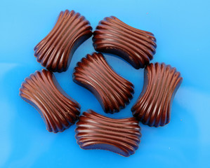 Assorted chocolate candies on blue background