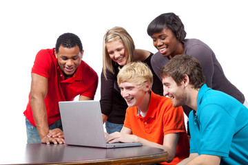 Multi-racial college students sitting around a computer