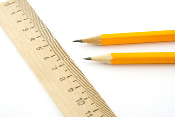 Ruler and two pencils isolated on white background