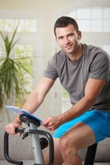 Fototapeta na wymiar Man training on exercise bike