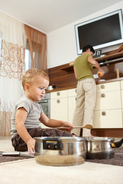 Little boy playing with cooking pots