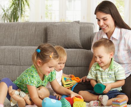 Mother playing with children at home