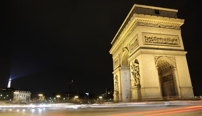 Arc de triumph with eiffel tower lighting, Paris, France.