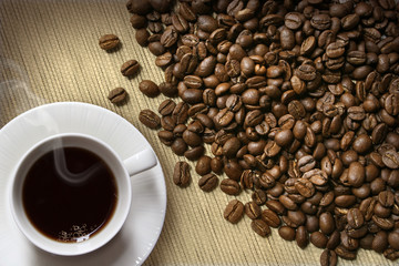 Coffee cup and beans on burlap