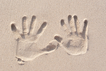 hand prints on the sand