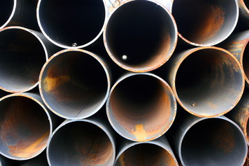 Close-up of steel high-pressure pipes bunch in warehouse