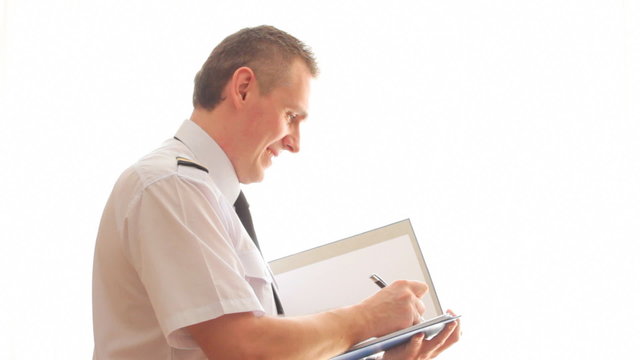 Airline pilot filling in and checking papers