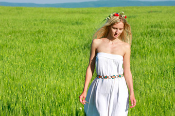 young beautiful woman in traditional clothes on natural backgrou