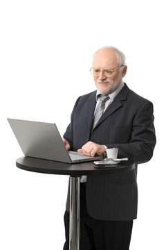 Happy senior businessman using computer