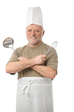 Senior cook with kitchen utensils