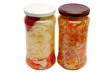 Glass jars with marinated vegetables  isolated on the white back