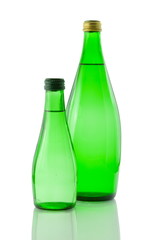 Bottles  of mineral water reflected on white background