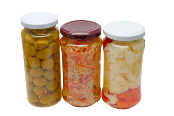 Glass jars with marinated vegetables  isolated on the white back