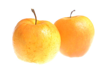 Two bright golden apples isolated on white background