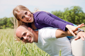 Happy couple enjoying with their arms outstreched