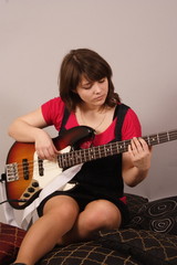 young beautiful woman with a bass guitar
