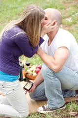 Happy woman kissing her boyfriend for the precious gift