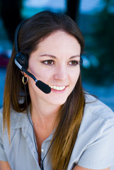 Woman talking on the phone in blue background.