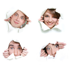 young couple peeping through hole in paper