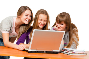 three teenager girls surfing the net