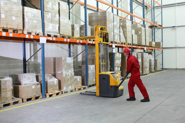 manual forklift operator at work in warehouse