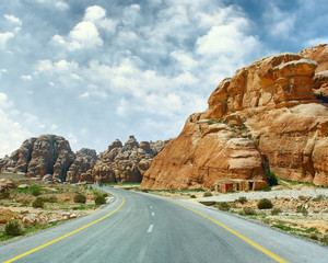 Asphalt road blue sky with clouds and mountains