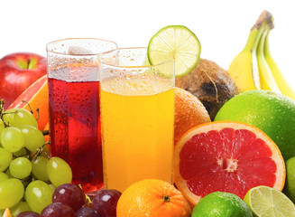 Fruits and slices near glasses with juice