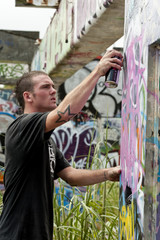 Fototapeta na wymiar teenage boys tagging painting graffiti