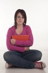 beautiful teenage girl enjoying reading book