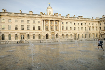Fototapeta na wymiar Boy running through fountain, Somerset House, London