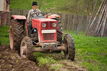 Fototapeta premium Old farmer plowing
