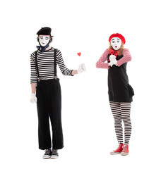 man giving small red heart to amazed woman