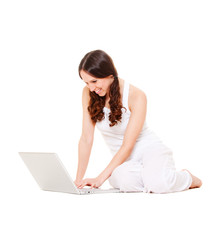 smiley student with laptop sitting on the floor