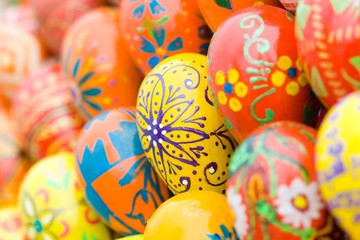 Fototapeta na wymiar Easter eggs background, focus on yellow egg.