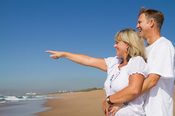 happy senior couple at the beach