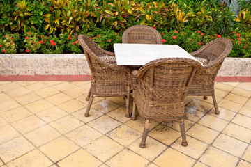 Brown wooden chairs an tables on patio