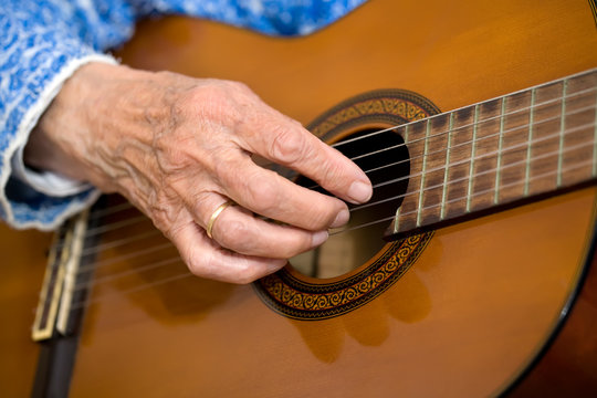 Old hands on guitar