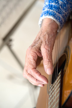 Old hand on guitar