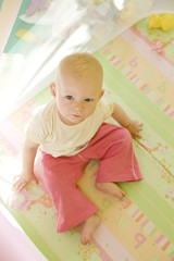 toddler sitting in cot