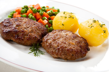 Fried pork chop  with boiled potatoes and vegetables