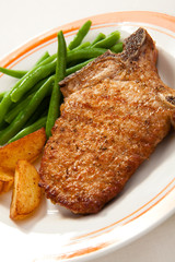 Grilled steak with chips and vegetables