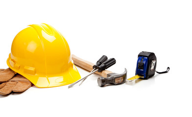Hard hat, gloves and tools on a white background
