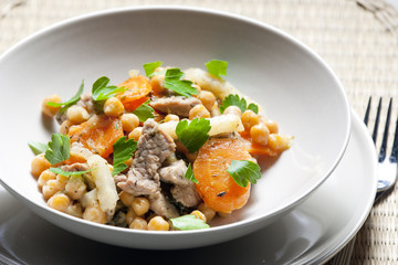 pork meat on celery with carrot and chick peas